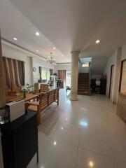 Spacious living room with modern furnishings and staircase