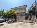 Two-story house with a gated front yard