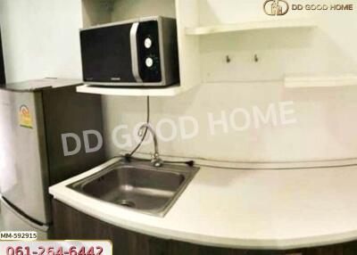 Compact modern kitchen with microwave and refrigerator