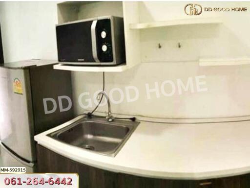 Compact modern kitchen with microwave and refrigerator