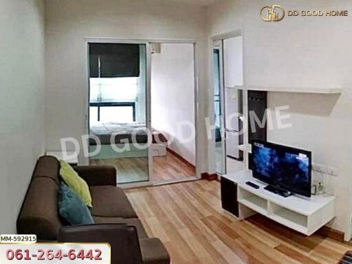 Spacious living room with modern decor and open access to the bedroom.