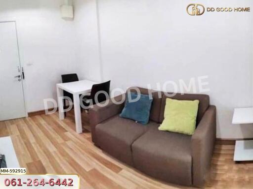 Living room with brown sofa and small dining table