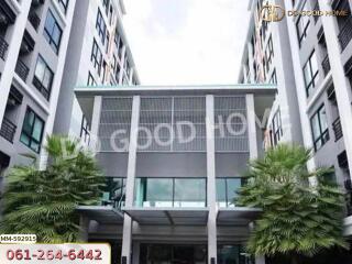 Front view of modern apartment building with greenery