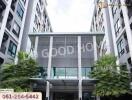 Front view of modern apartment building with greenery