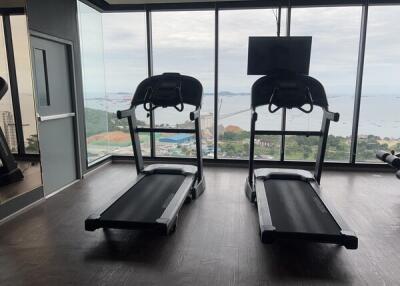 Fitness center with two treadmills facing large windows