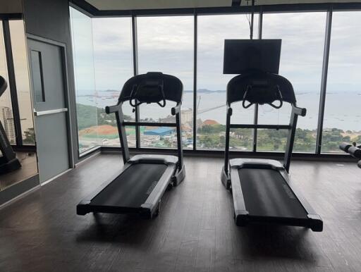 Fitness center with two treadmills facing large windows