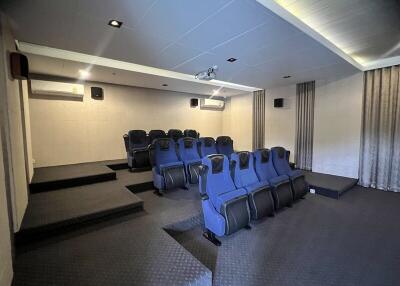 Home theater with tiered seating and projector