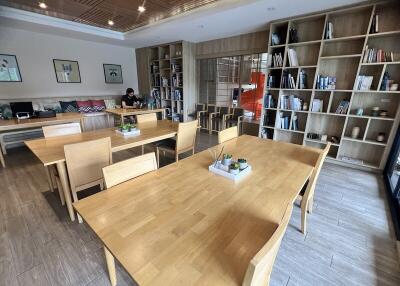 Lounge area with wooden tables and bookshelves