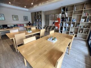 Lounge area with wooden tables and bookshelves