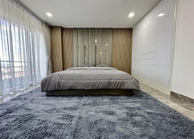 Modern Bedroom with Large Bed and Ample Natural Light