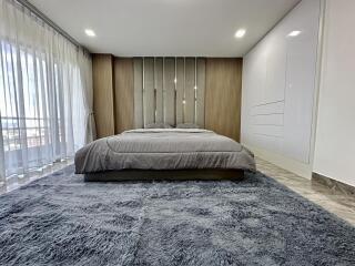 Modern Bedroom with Large Bed and Ample Natural Light