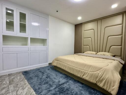 Modern bedroom with built-in storage and stylish bed