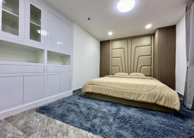 Modern bedroom with built-in wardrobes and a large bed