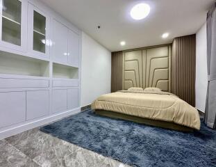 Modern bedroom with built-in wardrobes and a large bed