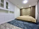 Modern bedroom with built-in wardrobes and a large bed