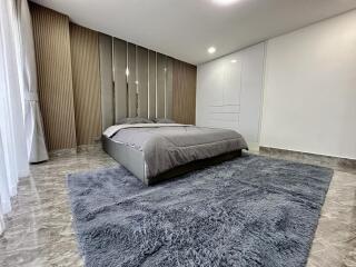 Modern bedroom with minimalist decor and large bed