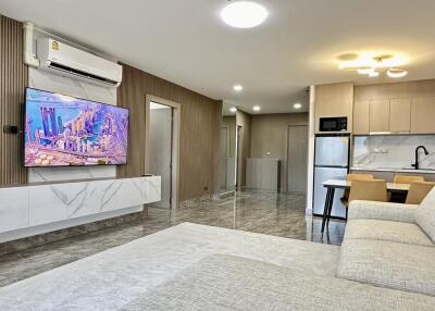 Modern living room and kitchen area with contemporary furniture and appliances