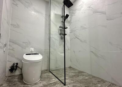 Modern bathroom with glass shower and toilet