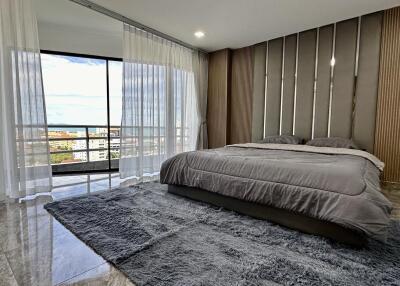 Modern bedroom with large windows and city view