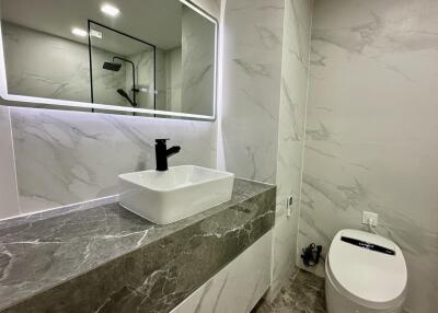 Modern bathroom with marble countertop and vessel sink