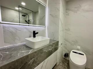 Modern bathroom with marble countertop and vessel sink