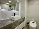 Modern bathroom with marble countertop and vessel sink