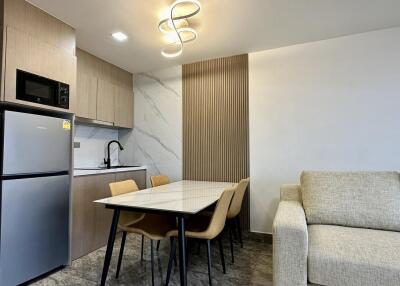 Modern kitchen and dining area with contemporary lighting