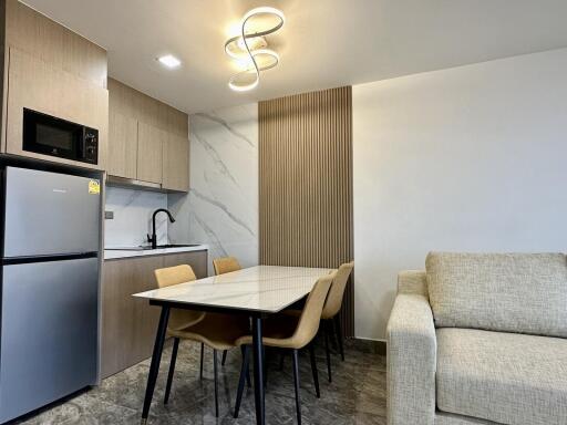 Modern kitchen and dining area with contemporary lighting