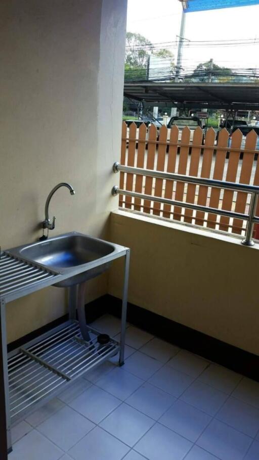 Outdoor kitchen sink next to a fence