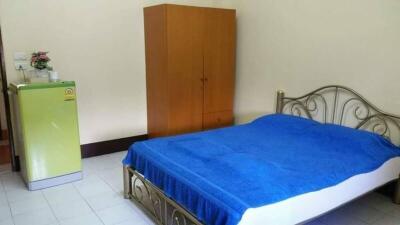 Cozy bedroom with blue bedding and a metal frame bed