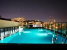 Rooftop pool at night with city view