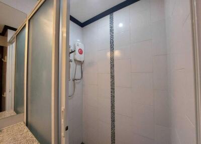 Minimalist bathroom with shower and water heater