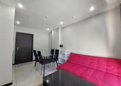 Modern living area with red sofa and dining table