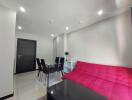 Modern living area with red sofa and dining table