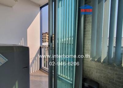 Bright balcony with glass sliding doors and partial view of the city