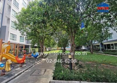 Outdoor area with colorful playground and adjacent residential buildings