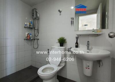 Modern bathroom with white tiles and sanitary fixtures