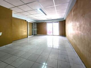 spacious empty room with tile flooring and large glass doors