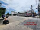 Street view with commercial buildings and some vehicles