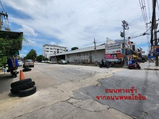 Street view with commercial buildings and some vehicles