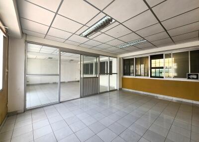 Spacious office space with tiled flooring and large windows