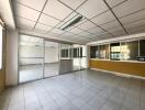 Spacious office space with tiled flooring and large windows