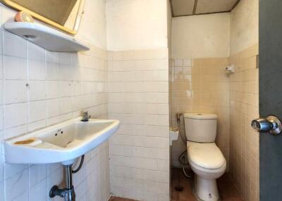 Bathroom with sink, mirror, and toilet