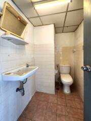 Bathroom with sink, mirror, and toilet