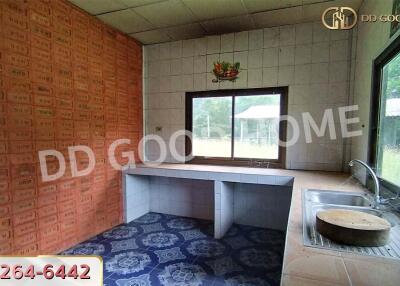 Simple kitchen with tiled walls and a window