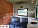 Simple kitchen with tiled walls and a window