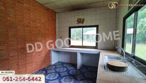 Simple kitchen with tiled walls and a window