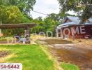 Outdoor view of a property with carport and garden