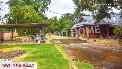 Outdoor view of a property with carport and garden