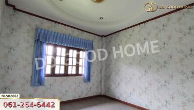 Bedroom with window and draped curtains